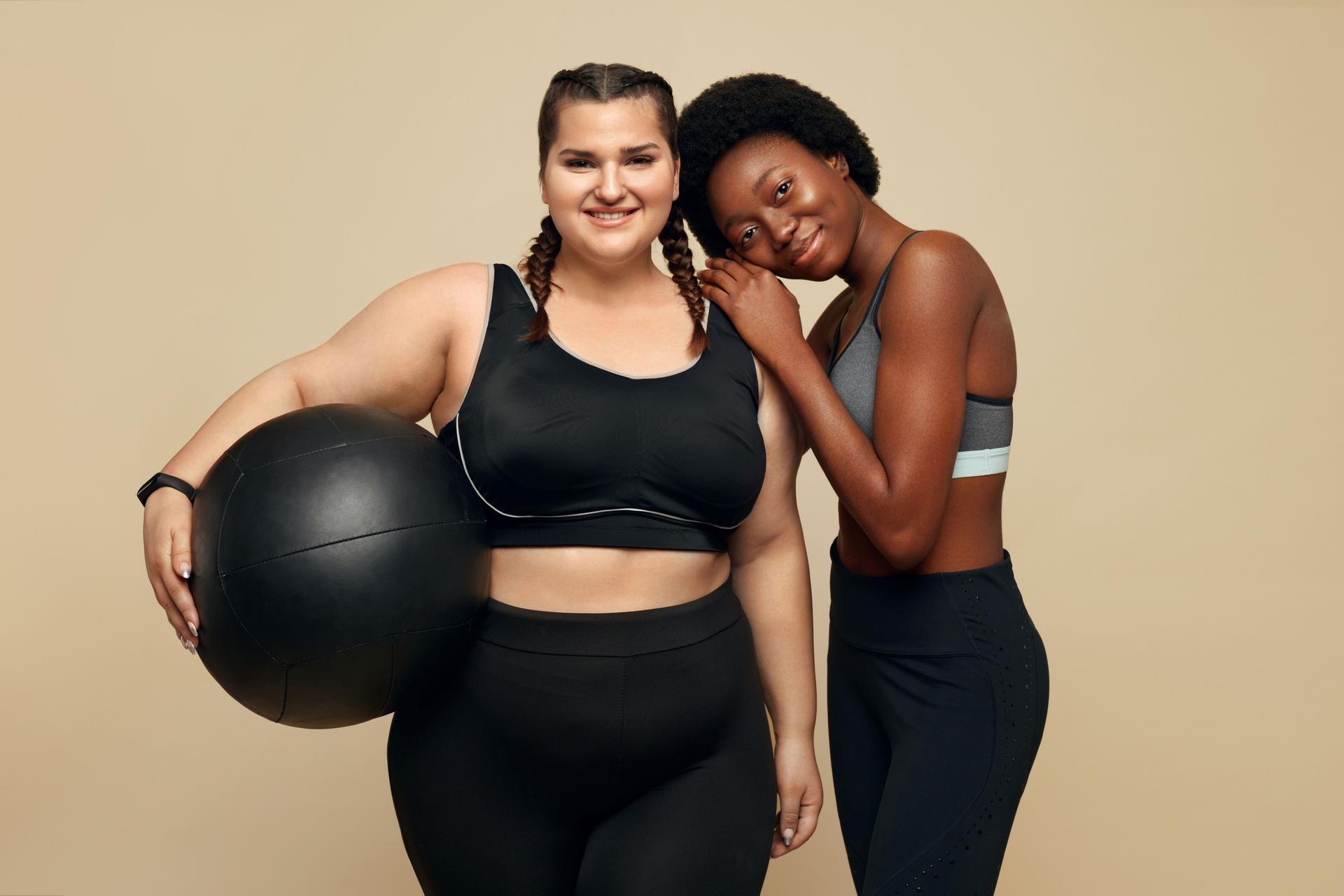 Fitness Friends. Slim And Plus Size Models. Two Different Women In Black Sportswear With Fitness Ball. Sport As Lifestyle.