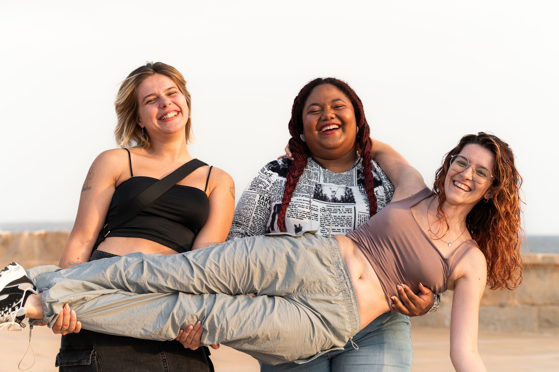 Women having fun and celebrating together next to the sea