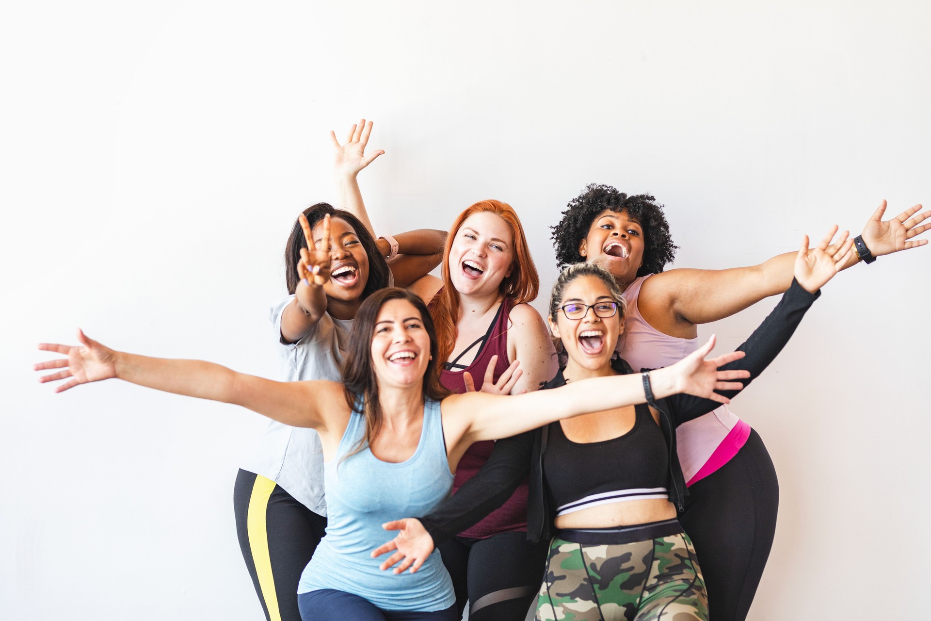 Diverse group of happy women, smiling women, celebrating women, and energetic women.